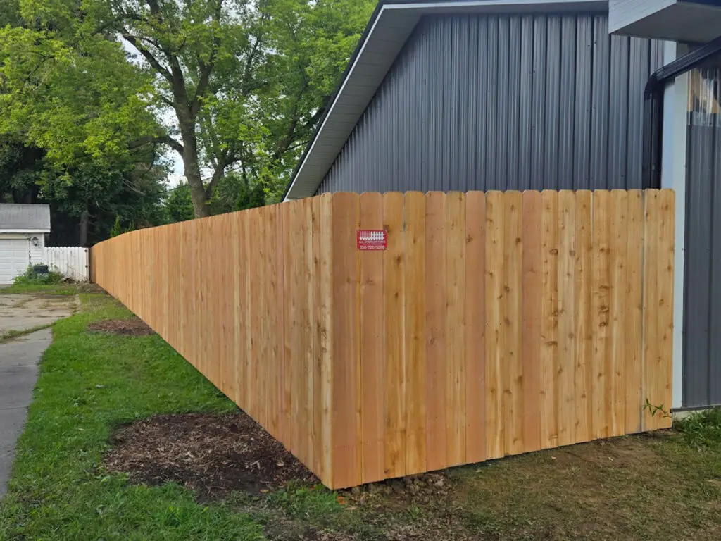Cedar privacy fence installed along a commercial property in Davison, Michigan.