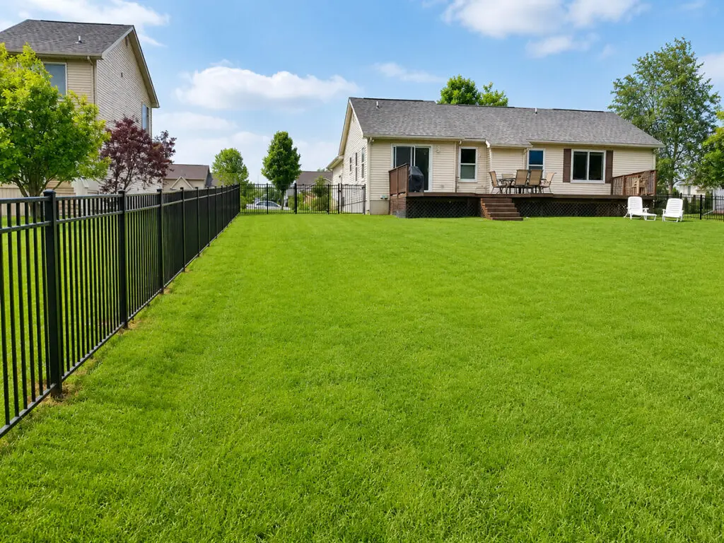Black Elite Fence Products aluminum fence surrounding a residential backyard in Davison, Michigan.