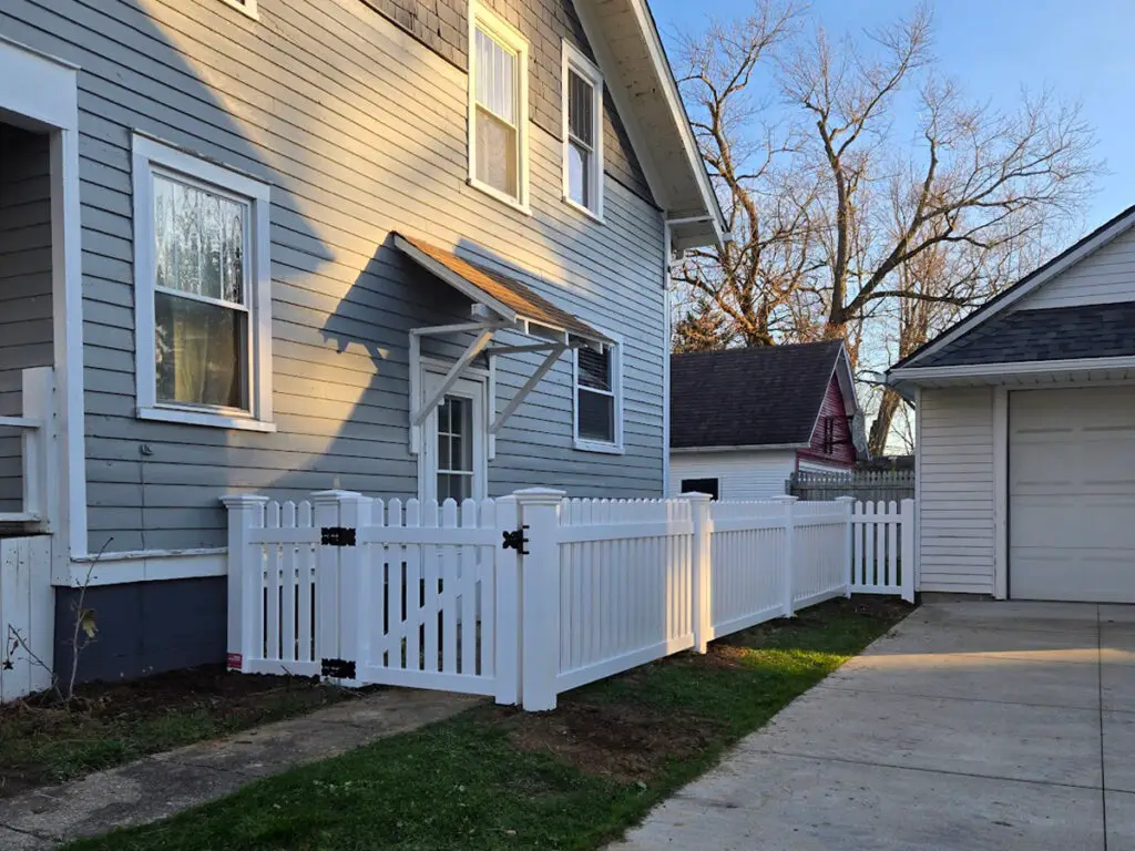 White Country Estate vinyl picket fence bordering a residential property in Davison, Michigan.